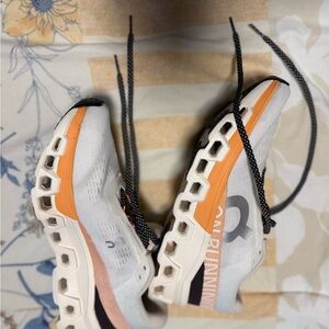 On Running Cream and Orange Sneakers